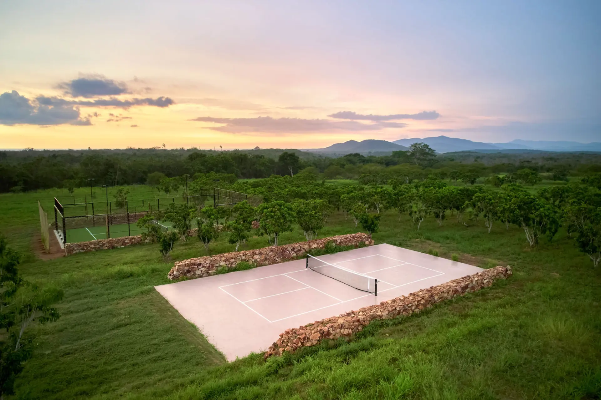 Tennis, padel and basketball courts at dusk